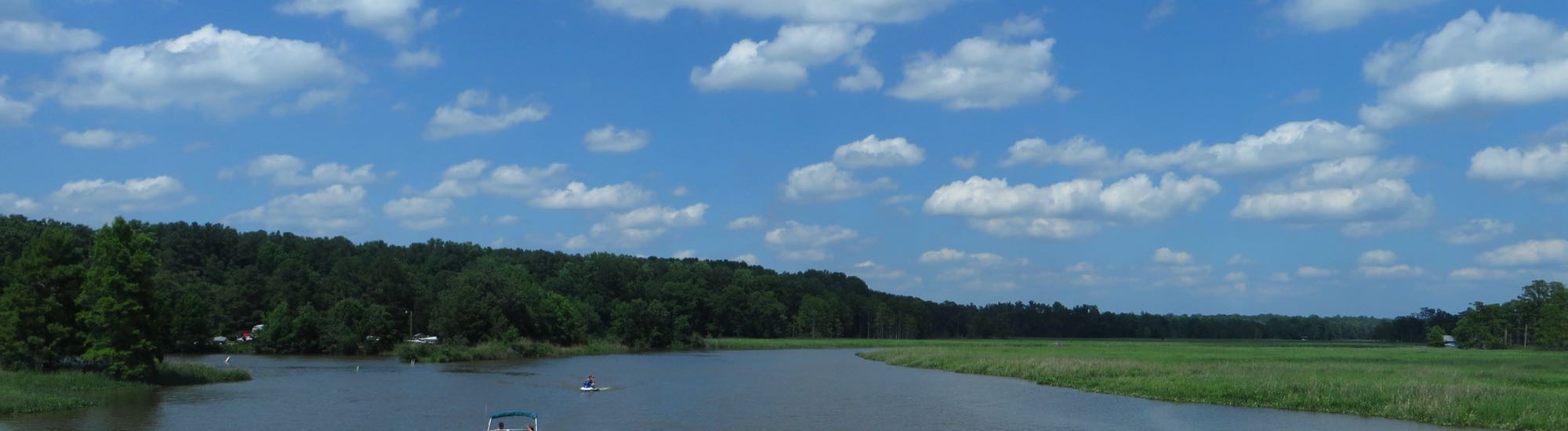 Powhatan Creek near the Colonial Parkway, with marsh grass and a small boat